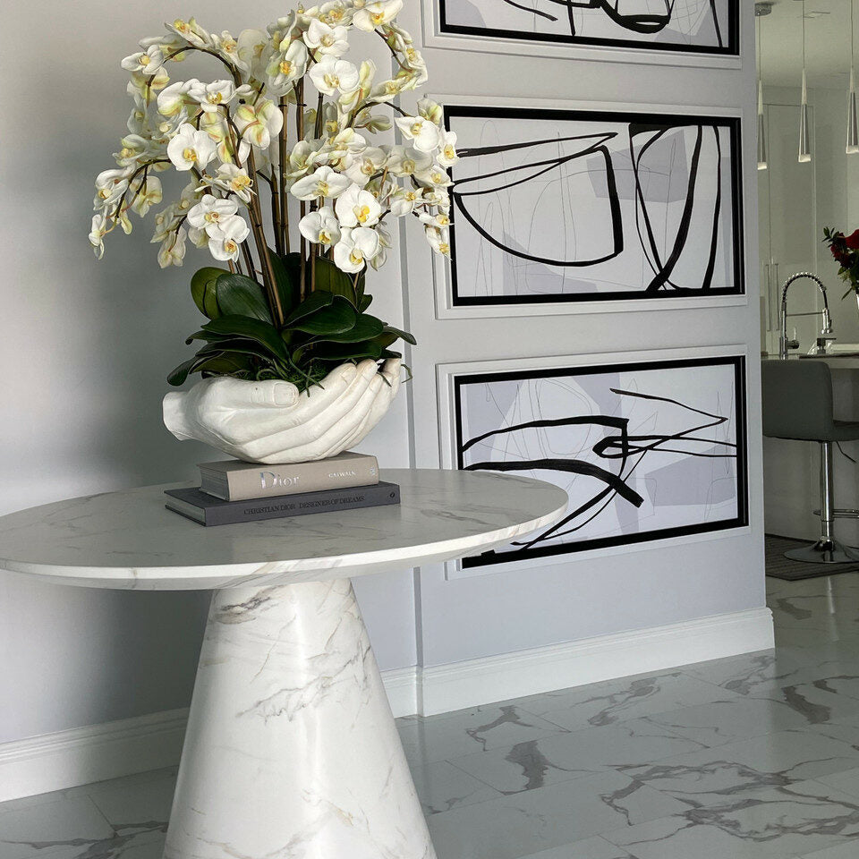 White Phalaenopsis orchids in a vase, open hand sculpture