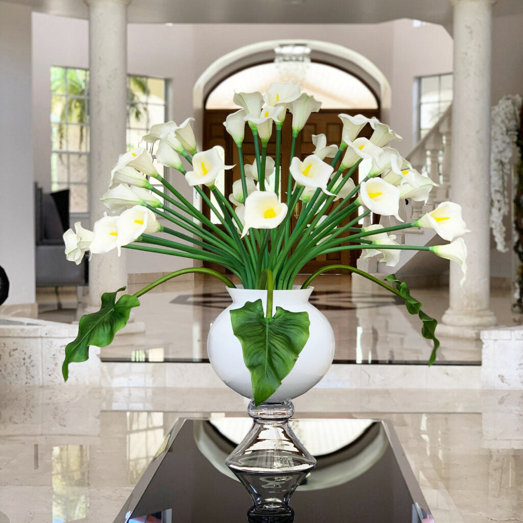 Elegant vase with several white calla lilies