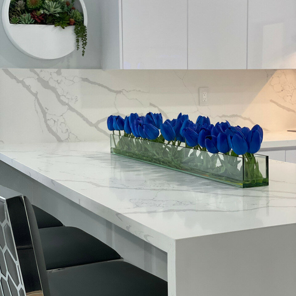 Modern glass vase with blue tulips
