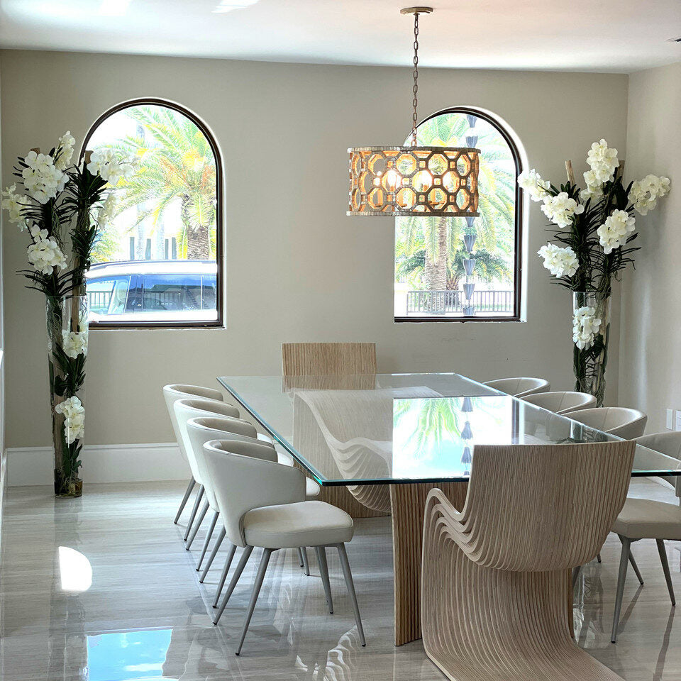 White Vanda orchids and driftwood in a large conical glass cylinder