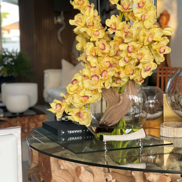 Yellow cymbidiums in a moon vase