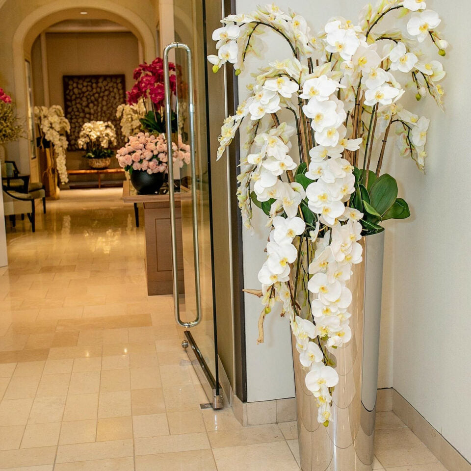 Cascading Phalaenopsis orchids on a polished stainless steel cone