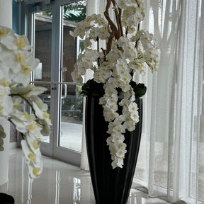 Glossy black San José vase with white orchid cascade