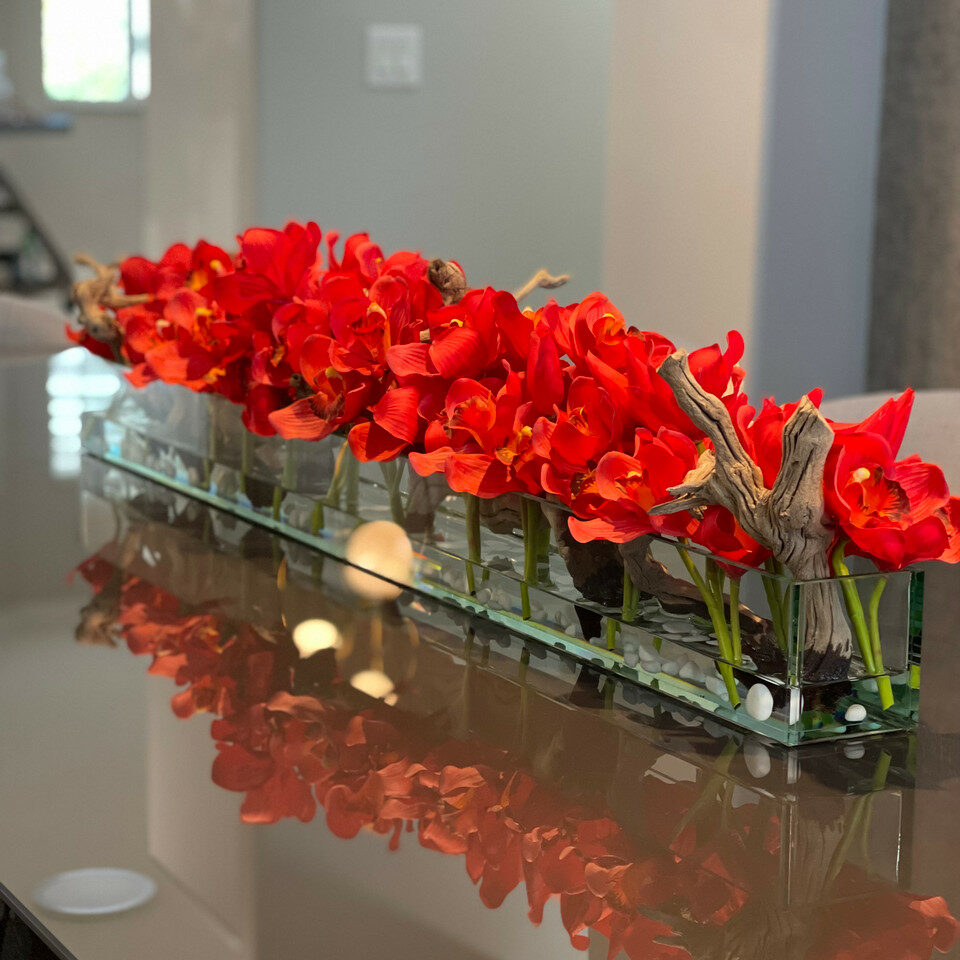 Modern glass vase in living style with red Cymbidium