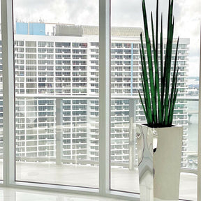 Stainless steel cube vase with snake grass