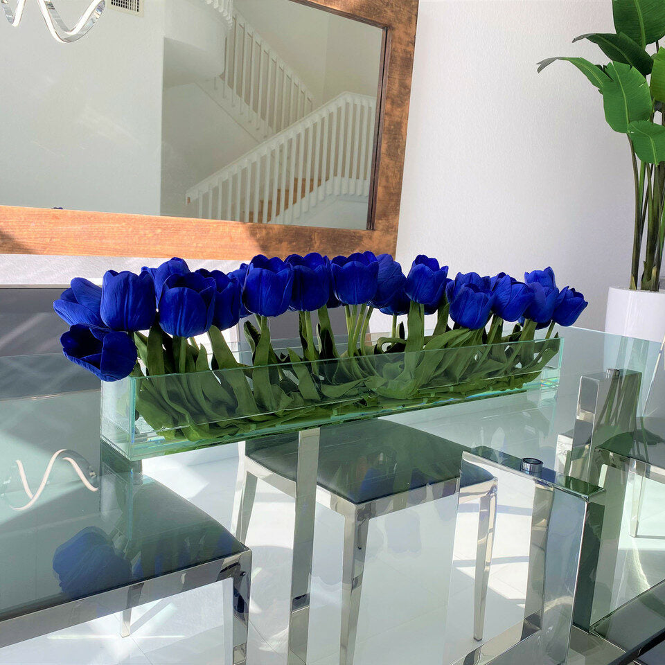 Modern glass vase with blue tulips