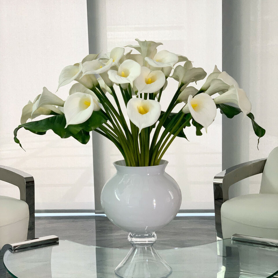 Elegant vase with several white calla lilies