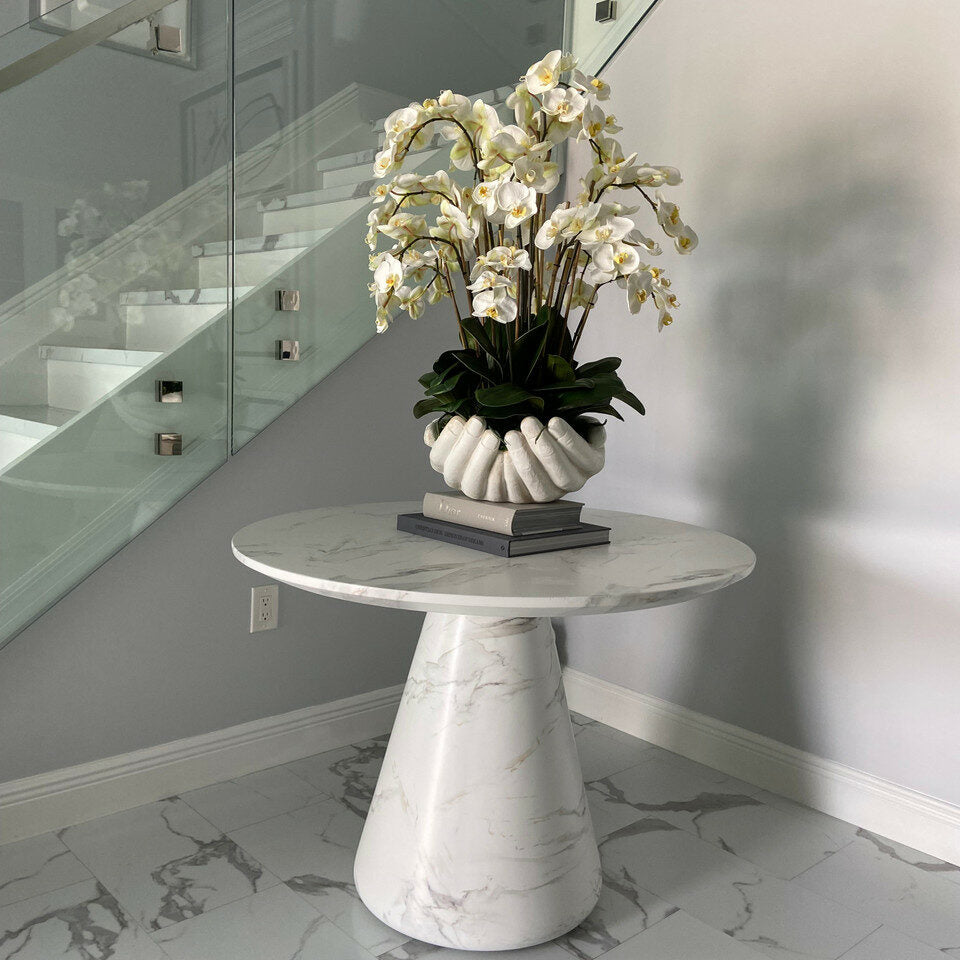 White Phalaenopsis orchids in a vase, open hand sculpture