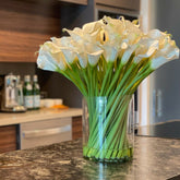 Cala lilies in a 10-inch glass cylinder
