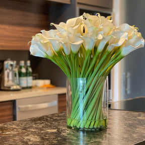 Cala lilies in a 10-inch glass cylinder