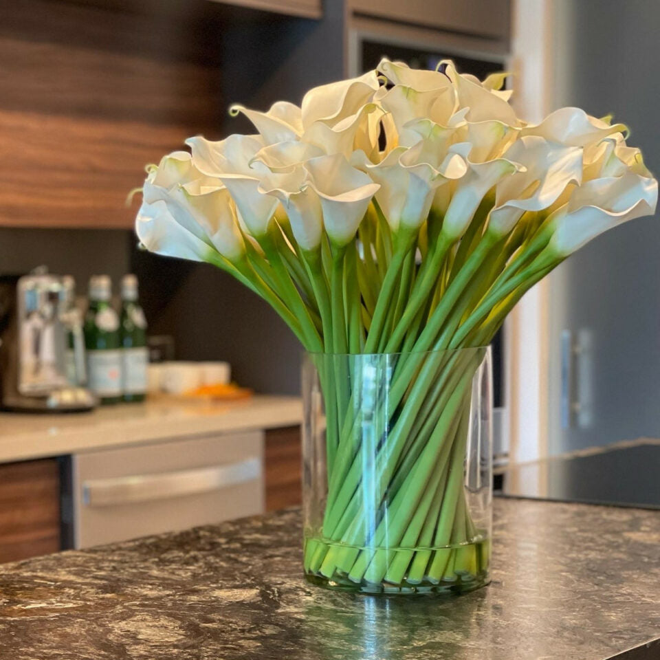 Cala lilies in a 10-inch glass cylinder