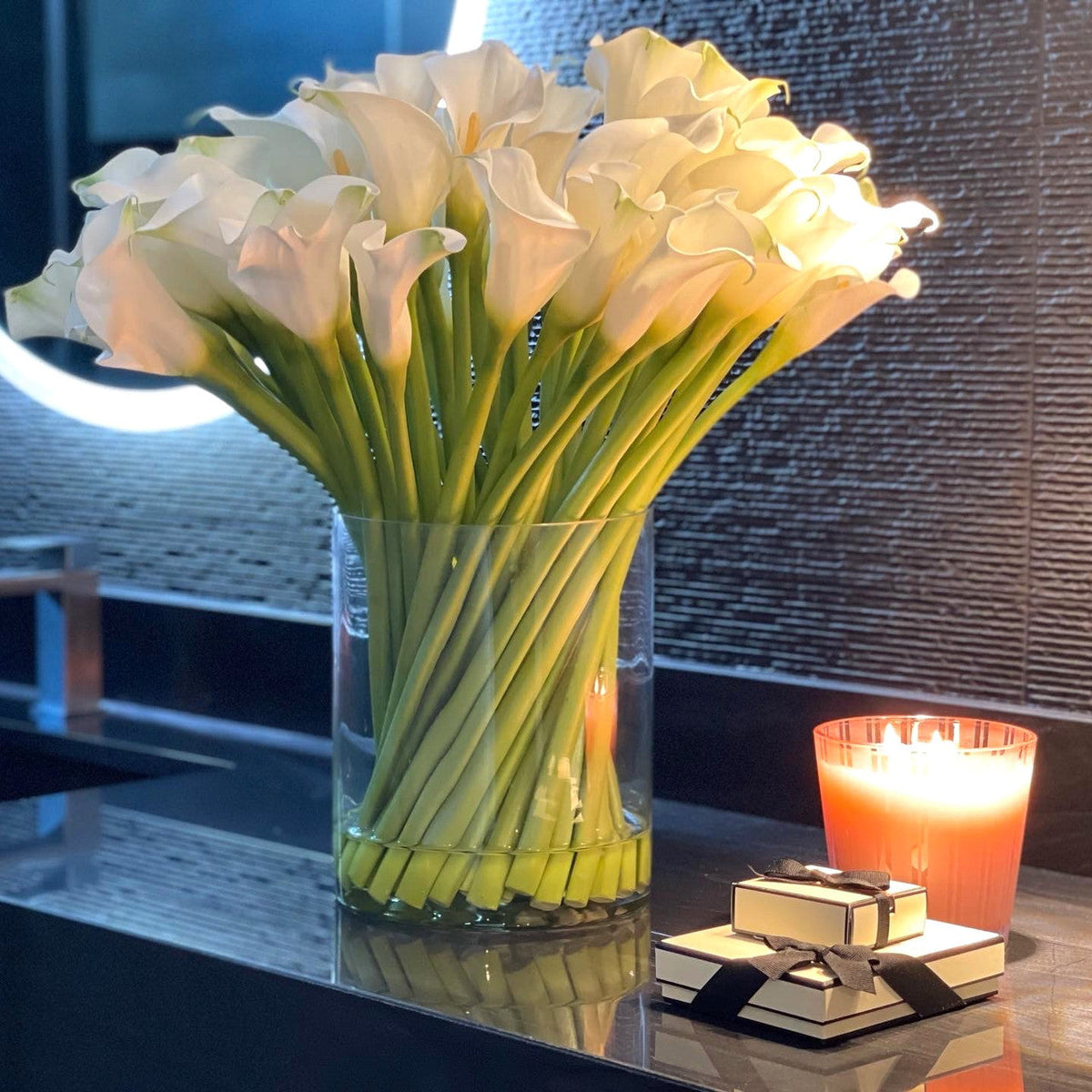 Cala lilies in a 10-inch glass cylinder