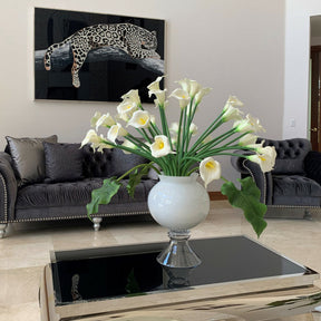 Elegant vase with several white calla lilies