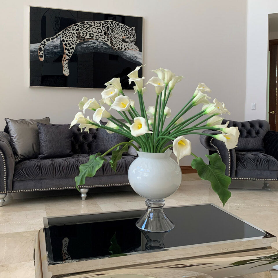Elegant vase with several white calla lilies