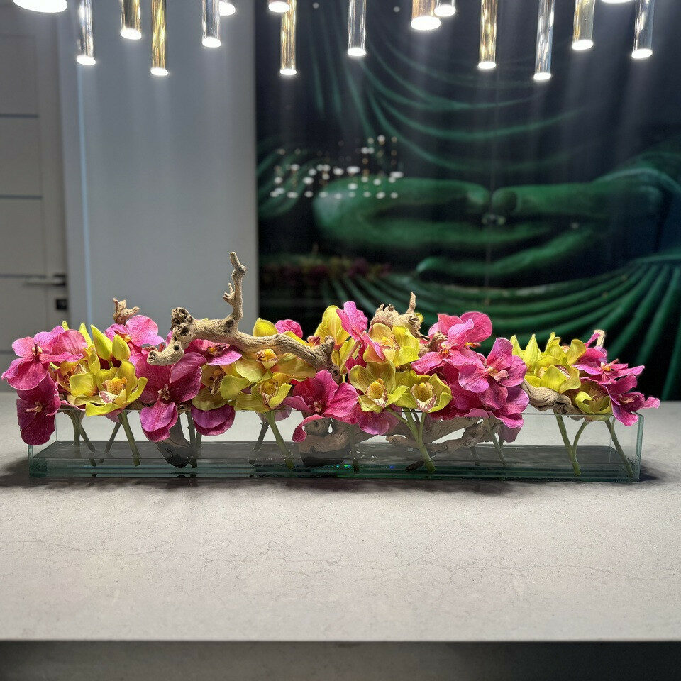 Modern glass vase with pink Vandas and green Cymbidium