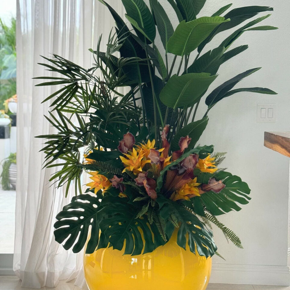 Tropical plant mix in a yellow spherical pot