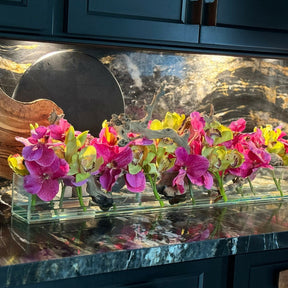 Modern glass vase with pink Vandas and green Cymbidium